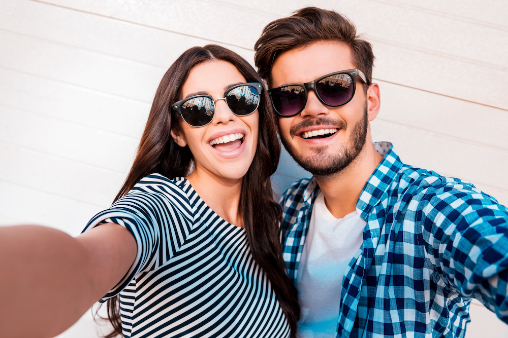 Two people in their 20's enjoying the UV protection that sunglasses from Hinsdale Eye Center can bring!